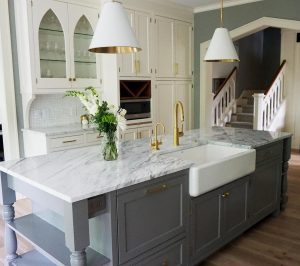 A kitchen in white and shades of gray with the kitchen island painted in Chelsea Gray by Benjamin Moore